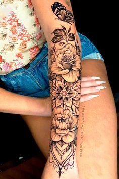 a woman's leg with flowers and butterflies on it