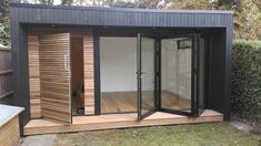 a small wooden building with sliding glass doors