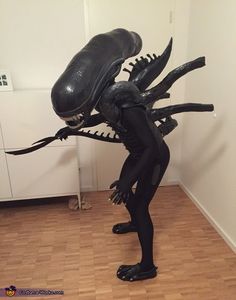 a statue of an alien standing in a room