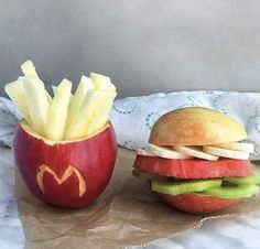 an apple and a hamburger sitting on top of a table