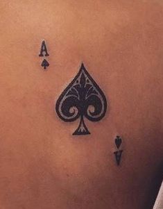 the back of a woman's shoulder with playing cards on it