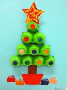 a christmas tree made out of toilet rolls and some colored paper with a star on top