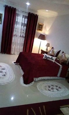 a bed room with a neatly made bed and curtains