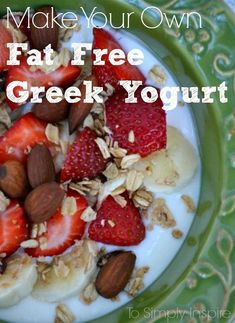 a green plate topped with yogurt and strawberries next to sliced almonds