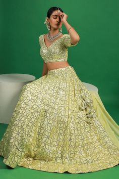 Lemon yellow lehenga with attached can can and sequin embroidered floral motifs. Comes with padded blouse and dupatta.
Components: 3
Pattern: Embroidered
Type Of Work: Thread, Sequin
Neckline: V-neck
Sleeve Type: Half
Fabric: Georgette
Color: Yellow
Other Details: 
Attached lining
Lehenga Length: 42 inches
Model Height: 5ft 4inches wearing size S
Closure: 
Lehenga: Side drawstring
Blouse: Back hook
Occasion: Mehendi and Haldi,Sangeet - Aza Fashions Pista Green Embellished Lehenga For Party, Embellished Pista Green Lehenga For Party, Party Embellished Pista Green Lehenga, Pista Green Embellished Party Choli, Yellow Embellished Designer Wear Sets, Designer Yellow Embellished Sets, Traditional Pista Green Dress With Sequins, Eid Embellished Pista Green Lehenga, Designer Pista Green Sequin Dress