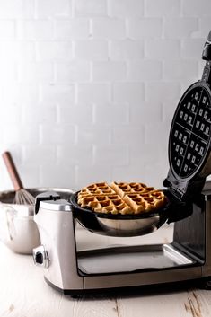 a waffle iron on top of a white counter