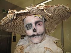 a man wearing a sombrero and skull makeup