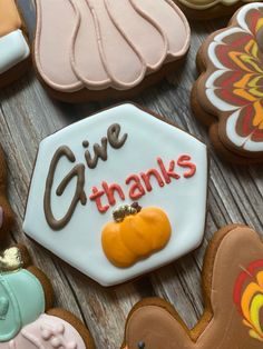 decorated cookies with the words give thanks written on one side and an orange pumpkin on the other