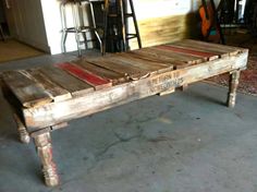 an old wooden table with red stripes on it