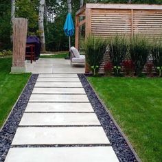 an outdoor patio with stone walkway and grass