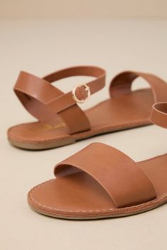 Get back to basics in the Insta-worthy Lulus Hearts and Hashtags Tan Flat Sandals! You can wear these vegan leather sandals anywhere, with their simple brown toe band and gold-buckled tan ankle strap. 0. 25" rubber heel. Smooth synthetic insole. Nonskid rubber sole. All Man Made Materials. Imported. Lulus | Hearts and Hashtags Tan Flat Sandal Heels | Size 5.5 | Vegan Friendly. Adjustable Slingback Sandals With Round Toe, Adjustable Brown Sandals For Everyday Wear, Trendy Brown Adjustable Sandals, Trendy Adjustable Brown Sandals, Trendy Brown Toe Loop Sandals, Trendy Brown Sandals For Everyday, Trendy Brown Sandals With Adjustable Strap, Brown Slingback Sandals For Everyday Spring Wear, Brown Trendy Sandals For Everyday Wear