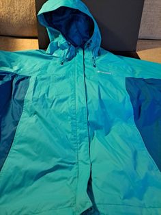 To tone teal, 2x, Columbia windbreaker/rain jacket. Great condition.  Zips and velcro close. Wrist velcro to keep out wind. Green Weatherproof Windbreaker For Rainy Weather, Blue Waterproof Windbreaker For Cold Weather, Green Nylon Windbreaker For Rainy Weather, Hooded Green Windbreaker For Rainy Weather, Green Nylon Windbreaker For Cold Weather, Sporty Green Windbreaker For Rainy Weather, Blue Windproof Windbreaker For Rainy Weather, Green Windproof Windbreaker For Rainy Weather, Green Waterproof Windbreaker For Rainy Weather