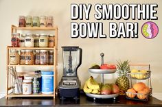 there is a blender and some fruit on the counter with words over it that says diy smoothie bowl bar