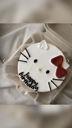 a hello kitty birthday cake with red bow on it