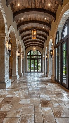 a large foyer with stone floors and arched doorways