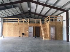 the inside of a building with two doors and some stairs in it's center