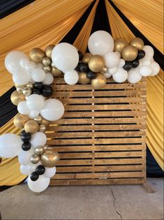 balloons and streamers decorate the entrance to a marquee