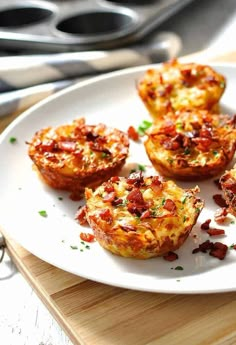 some bacon and cheese muffins on a white plate