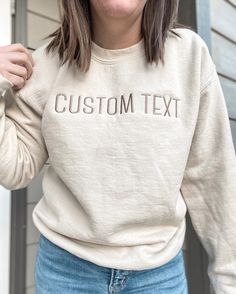 "CUSTOM TEXT EMBROIDERED APPAREL ♡ Heavy Blend Crewneck Sweatshirt - Unisex ♡ Custom Text ♡ 50/50 Cotton/Polyester ♡ Made in the U.S. ♡ Model is wearing \"Sand\"; Size: S; Embroidery Thread: \"Brown\"; Font: \"Canter\" IMPORTANT NOTICE: Crewnecks now have a paper like stabilizer that appears on the inside. This helps with increasing quality and ensure a longer lasting design on the sweatshirts. NOTE: Personalization will appear exactly as typed. Please ensure that all capital letters and spellin Brown Embroidery, Embroidered Apparel, Letter Sweatshirt, Embroidery Shop, Embroidered Crewneck, Embroidered Clothes, Custom Letters, Custom Apparel, White Embroidery