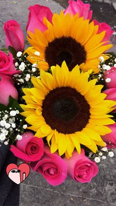 a bouquet of sunflowers and pink roses