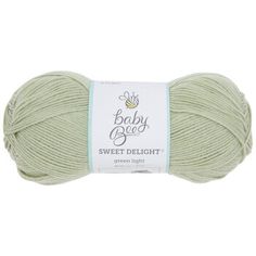 a ball of yarn with the words baby bee sweet delight in white and green colors