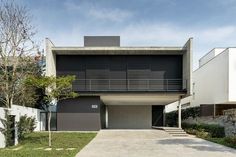 a modern house in the middle of a grassy area with stairs leading up to it