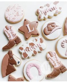 decorated cookies are arranged on a white surface