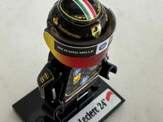 a close up of a race helmet on a stand