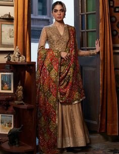 Traditional Pishwas Pakistani Wedding Dress in Raw Silk is a beautiful attire adorned with Luxury details of Embroidery, Gota, and Tilla. Custom sizes. Pishwas Pakistani, Faiza Saqlain, Angrakha Style, Desi Wedding Dresses, Frock Style, Pakistani Wedding Dress, Pakistani Bridal Dresses, Silk Dupatta, Pakistani Bridal