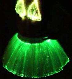 a green skirt is lit up in the dark