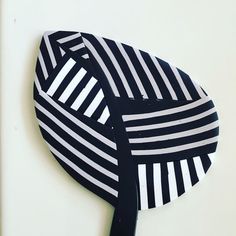 a black and white striped hat is hanging on the wall