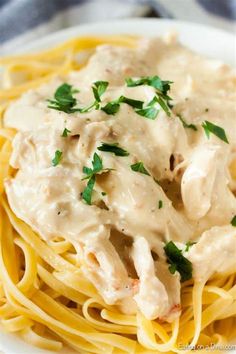 a white plate topped with pasta covered in gravy