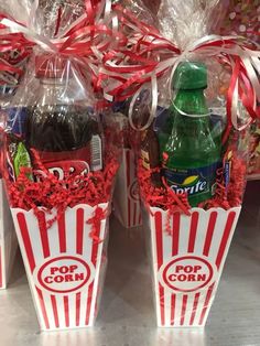 two popcorn buckets filled with soda and candy