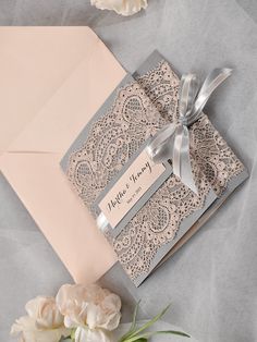 a wedding card with a ribbon and lace on it