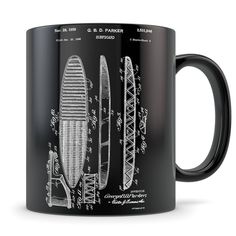 a black coffee mug with a drawing of a boat and paddleboat on it's side