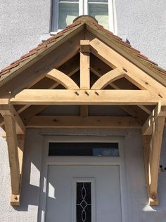 a white front door with a wooden roof