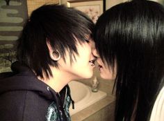 two people kissing each other in front of a bath tub