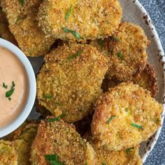 some fried food on a plate with dipping sauce