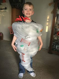 a young boy is dressed up as a ghost