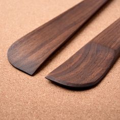 two wooden spoons sitting on top of a table