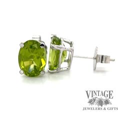 A pair of perfectly matched oval peridots are secured in 14 karat white gold stud earrings. The peridots have a total weight of 2.65 carats and are mounted in four prong double gallery friction posts with 14 karat friction ear backs. The peridot stones display very good saturation and intensity with the fresh spring time green color that they are know for. Hallmarked Oval Peridot Jewelry, Oval Gold Multi-stone Earrings, Peridot Earrings Studs, Oval Peridot Multi-stone Jewelry, Oval Multi-stone Peridot Gemstones, White Gold Stud Earrings, White Gold Earrings Studs, Peridot Stone, Gold Stud