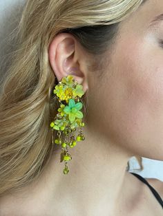 Vintage Colleen Toland Chandelier Earrings from the 1990s.  Striking bright green into yellow (chartreuse) with elaborate beading made up of hand painted resin flowers and glass beads.  The fringe is made with metal leaves and unique square glass drop beads.  These earrings are clip on and are comfortable to wear.  Colleen's name is engraved on the back of the clip.  These earrings can be converted into pierced if you request that.  They measure 2.5 inches long. Most of the works shown are the last pieces from Colleen's archive.  They are no longer in production and will not be remade.  They are not pre-owned and have never been worn.  They come with a certificate of authenticity that catalogs the piece and guarantees that it is a genuine Colleen Toland work of art. A bit about Colleen. Green Dangle Flower Earrings For Party, Bohemian Green Flower Earrings For Party, Yellow Dangle Flower Earrings For Party, Unique Green Dangle Flower Earrings, Green Dangling Bead Flower Earrings, Yellow Dangle Chandelier Earrings For Party, Green Dangle Flower Earrings With Beads, Green Flower Drop Earrings With Dangling Beads, Handmade Green Chandelier Earrings For Party