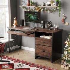 a desk with a computer on it in front of a christmas tree and other decorations