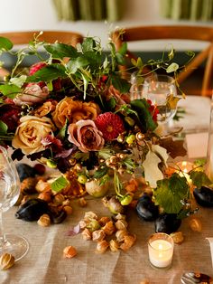 a table topped with lots of flowers and candles