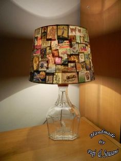 a lamp that is sitting on top of a wooden table in front of a wall