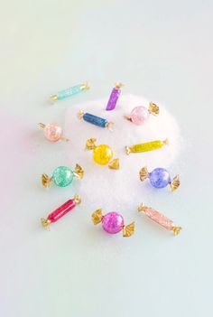 there are many candy candies on top of the white snow covered ground with gold ear pins