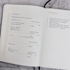 an open notebook with some writing on the page and a black cord attached to it