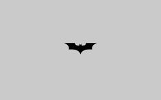 the dark knight logo is shown in black on a light gray background, and it appears to be batman symbol