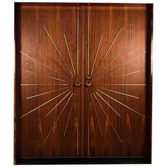 an art deco style wooden door with gold lines and sunbursts on it