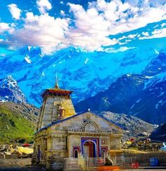 an old church with mountains in the background